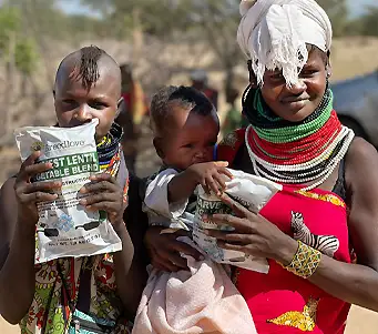 Family in Kenya holding Breedlove distributed food.